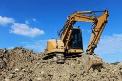 A backhoe is a large machine used to drill the soil surface.