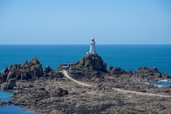 La Corbiere lighthouse on the headland of St Brelade in the south-west of the British Crown Dependency of Jersey, Channel Islands, British Isles.
