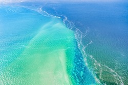 Meeting of two seas, Kinburn Spit, Ukraine, amazing aerial view. The border of the blue Black Sea and the Dnieper river, wild nature, beautiful landscape, in bright sunny weather.