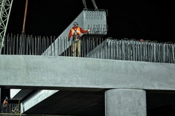 Concrete girders installation  on a bridge abutment and center pier as part of a new interchange in southern Saskatchewan Canada for a new freeway system and extension of the Trans-Canada Highway