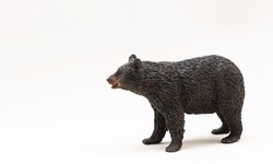 Miniature figure of a toy bear, isolate on a white background. Russian brown bear. Copy space