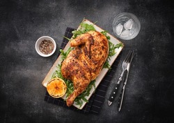 Grilled chicken. Half baked chicken with lemon and spices. Delicious juicy chicken. Grilled poultry.