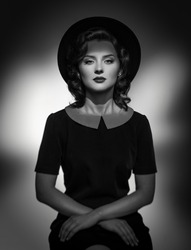 Black and white Retro classic portrait of elegant woman in hat and dress. Studio shot.