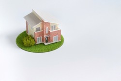 Plastic model house placed on the table (my home plan image)