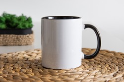 Two tone black and white mug mockup for presentation sublimation designs. Stock photos of white coffee mug ont he table with minimalist decoration for designers