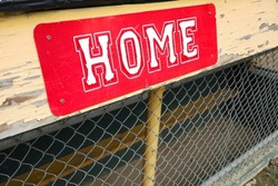 Weathered Red Home Team Sign on Little League Field Dugout