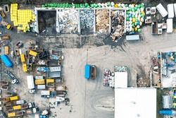 A lot of containers for collecting city garbage, sorting and processing garbage, a garbage truck for transporting and collecting garbage. View from above