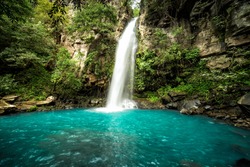 Majestic waterfall in the rainforest jungle of Costa Rica.  La Cangreja waterfall in Rincon de La Vieja National Park, Guanacaste