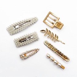Pin set beauty trendy accessories hair pearl clip on white background. Top view. Copy space fot text. 