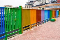 Closeup of rainbow colored railings in the city