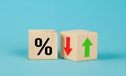 Cube block with percentage symbol icon. Interest rate financial and mortgage rates concept. Wood cube change arrow down to up. Interest rate, stocks, ranking. Business and finance concept.