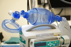 Respiratory mask with resuscitator for ventilation of a patient with pneumonia in the operating room of a hospital                               