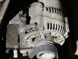 Old car alternator with unstrung belt close up, motor service repair