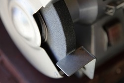 Grinding machine sharpening disk close-up. Metal working DIY tool