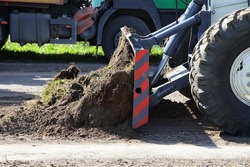 Suburban highway road repair works, Heavy bulldozer shovel levels asphalt surface close up. Asphalt laying