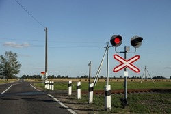 Road sign with railway red traffic light on countryside empty one way railroad crossing at Sunny summer day