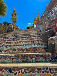 The ascent stairs are decorated with glass mosaic art and colorful tiles. with the blue sky