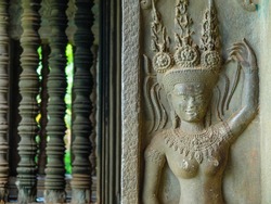 Dancing apsara and colons, an old ornament on the ancient wall, Angkor Wat, Cambodia