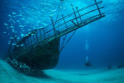Women diver explores the wrecks at the Bridge dive site on the island of Sint Maarten, Dutch Caribbean