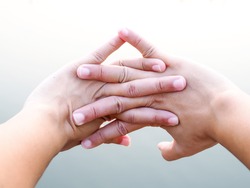 Close-up on fingers of asian people with hand stretched out and exercise in park to relax muscles relieve fatigue, Healthcare and medical concept.