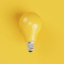Yellow Light bulb on yellow background. top view. minimal concept.
