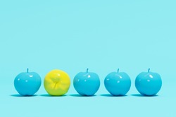 Outstanding yellow apple contrast blue appples on blue pastel background. minimal concept.