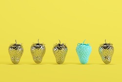 Outstanding blue strawberry with chrome strawberry on yellow background. minimal food idea concept.