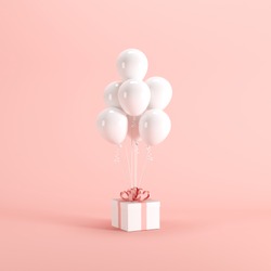White gift box with red ribbon and white balloon on pink background. minimal christmas new year concept.