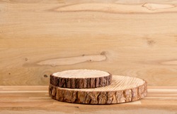 Two pine tree wood discs stacked as a podium for products, natural wood board background with lot of copy space, studio shot.