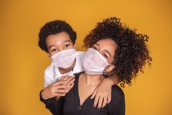 Portrait of young African American mother with toddler son using mask. mother and son wearing mask to protect covid 19, quarantine. Stay at home concept. 