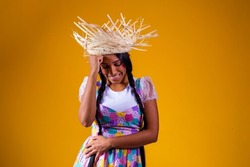 Girl dressed in typical clothes for the Brazilian June party dancing