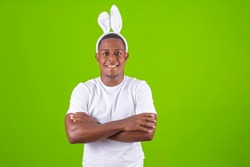 young boy with bunny ears and arms crossed smiling at camera