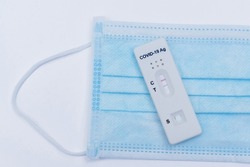 Hands holding Covid-19 rapid antigen test cassette with positive result of rapid diagnostic test. Self isolation