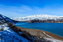 View to th Snow on the Lake coast of Ugam-Chatkal national park, Uzbekistan 