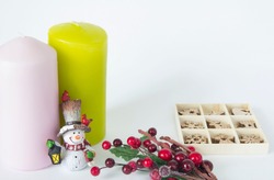 Christmas card with candles and Christmas set of toys with a branch of berries