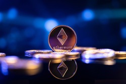Ethereum (ETH) cryptocurrency coin in front of an abstract blue virtual background