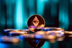 Ethereum cryptocurrency coin in front of blue digital abstract background