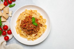 Tagliatelle all ragù - italian egg pasta with meat  and tomatoes bolognese sauce. Top view. Copy space.