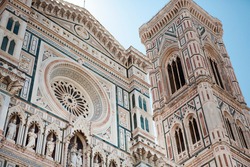 Close up. The white marble facade (exterior) of the central church (Duomo), also known as Santa Maria Cathedral, with the tower and the Renaissance dome in Florence, Tuscany, Italy. Europe