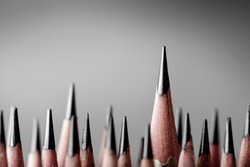 One pencil standing out from the group of other pencil.Leadership and growth in business concept.
