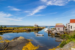 A typical scenic, small fishing village and harbor in the Maritimes,a tourist destination  on Nova Scotia, Canada, lots of blue water and skies