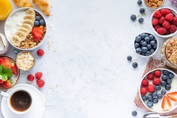 Healthy breakfast set on grey background. The concept of delicious and healthy food. Top view, copy space.