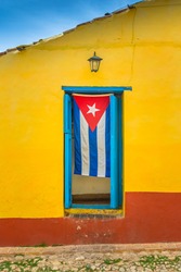 Cuban flag hanging down in door frame in Trinidad, Cuba 