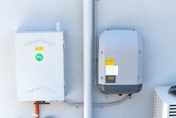 Solar inverter and meter box on the side of a house