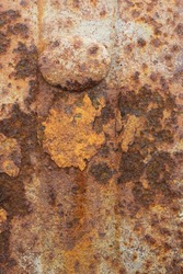 Full frame closeup of a traditional rusted metal wagon wheel.