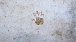 Single hand print on outdoor old cement wall. Abstract grunge background texture. Copy Space