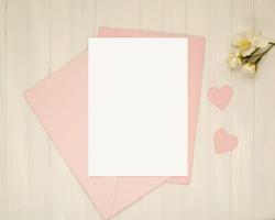 Valentines day greeting card mockup, vertical 5x7 empty card, invitation, pink envelopes and paper hearts, love letter, romantic concept.