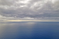 View of the ocean and overcast skies. The background of nature