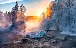 Dawn fog over a winter forest river. Morning fog on winter forest river. Winter river in morning fog at dawn. Winter forest river in fog at dawn