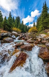 River waterfall in mountain forest. River waterfall rocks. Waterfall of river flow. Waterfall rocks